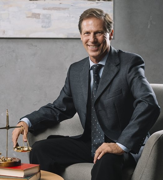 Attorney sitting on a chair and smiling